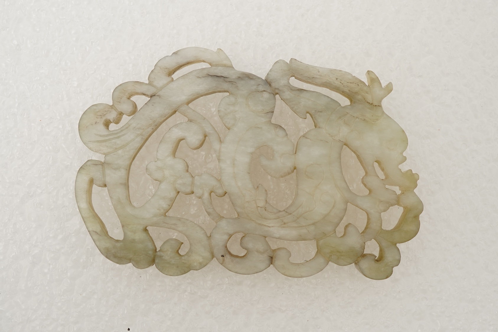 A Chinese white and grey mottled jade ‘chilong’ plaque, Ming dynasty